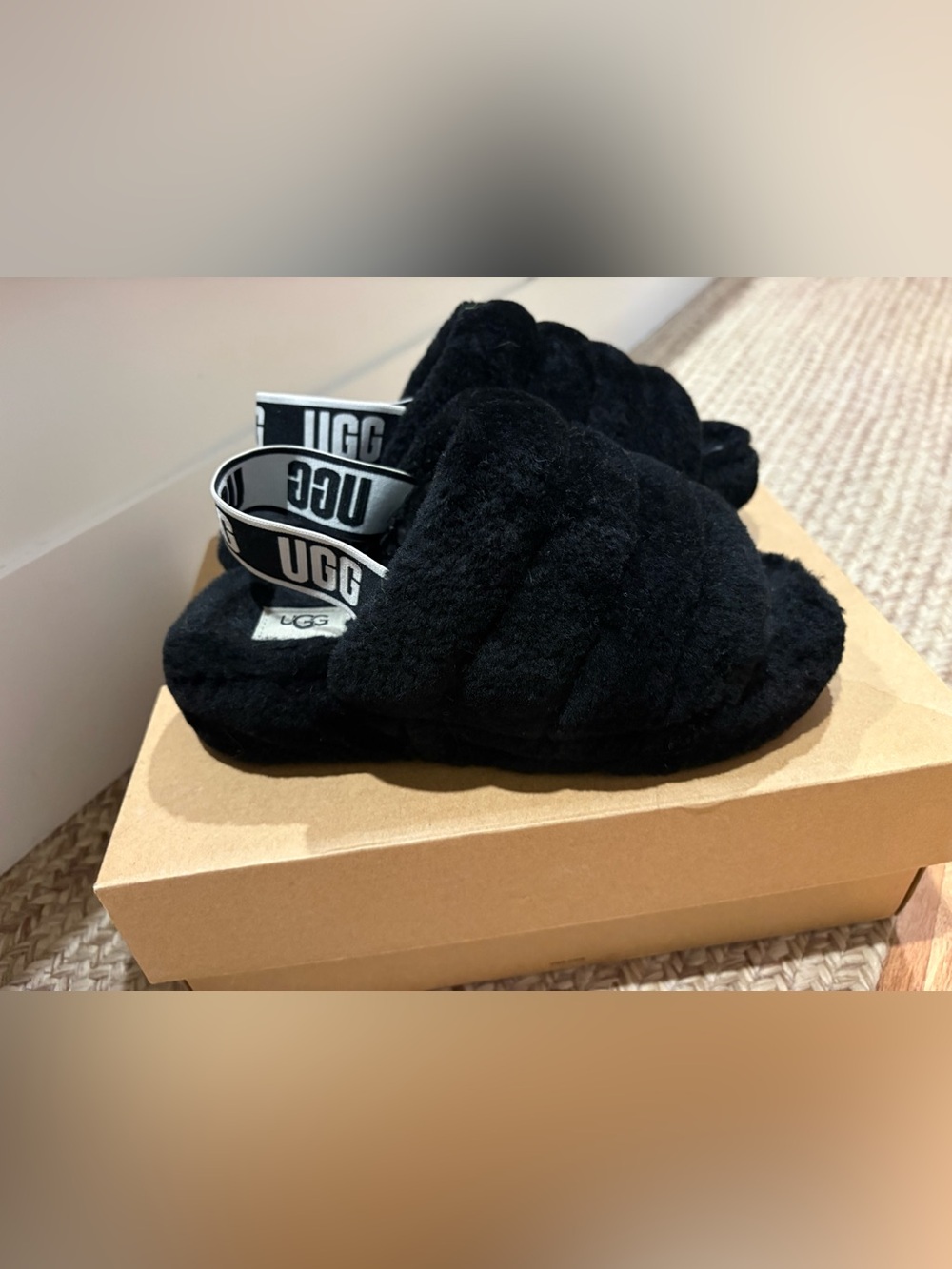 UGG women’s Black Fluff Slide Sandals with Logo Strap